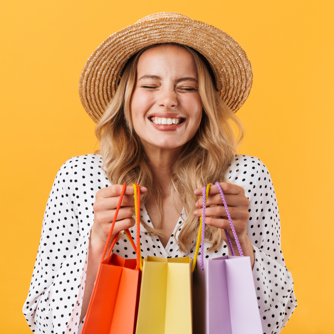 smiling woman holding shopping bags. customer who was satisfied with a bigcommerce store design and converted into a sale