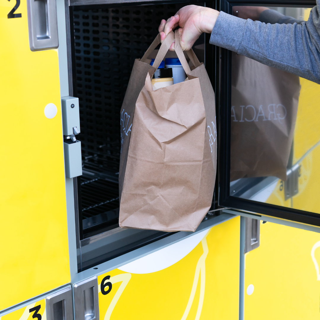 Person picking up groceries from grocery locker bought through a BigCommerce BOPIS app