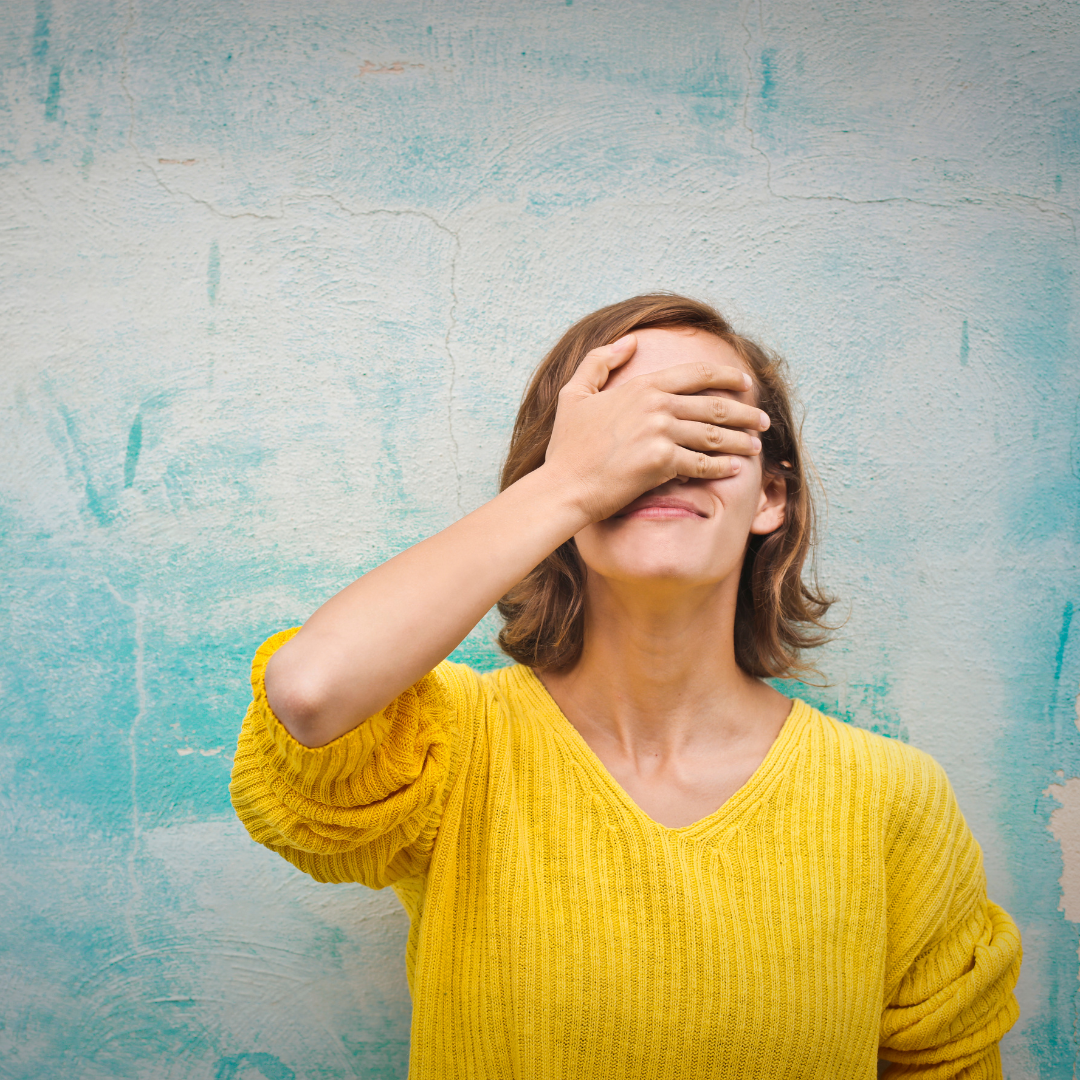 woman covering her face to symbolize BigCommerce website mistakes